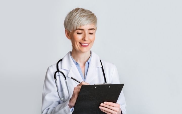 medical cannabis doctor processing information on a clipboard 
